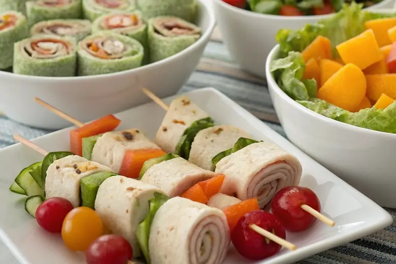 Delicious cold lunch ideas for kids with skewers, wraps, and salad.